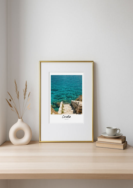Framed artwork of a coastal scene with 'Croatia' text on a shelf.