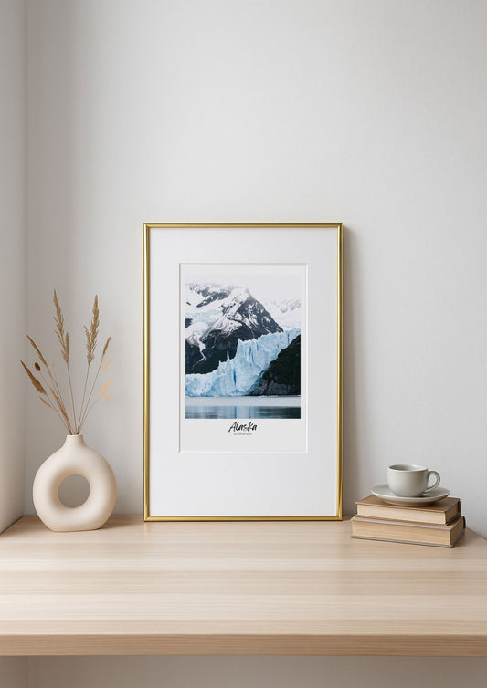 Framed photograph of a mountain on a shelf with decorative items