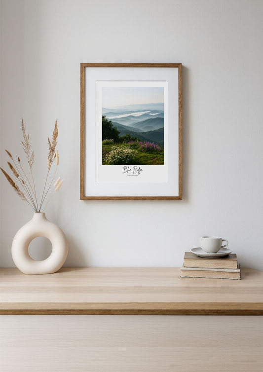 Framed landscape print on a wall above a wooden shelf with decor items.