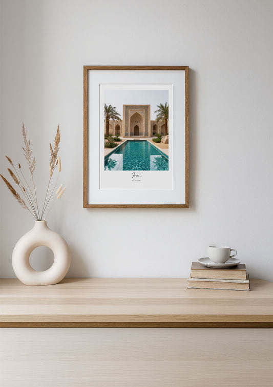 Framed artwork of a pool scene on a wooden shelf with decor items.