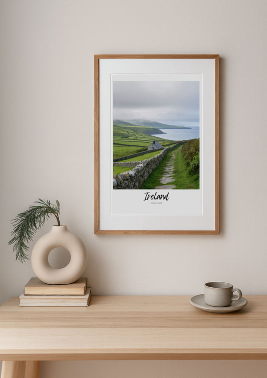 Framed print of Ireland on a wall above a wooden table with decor items.