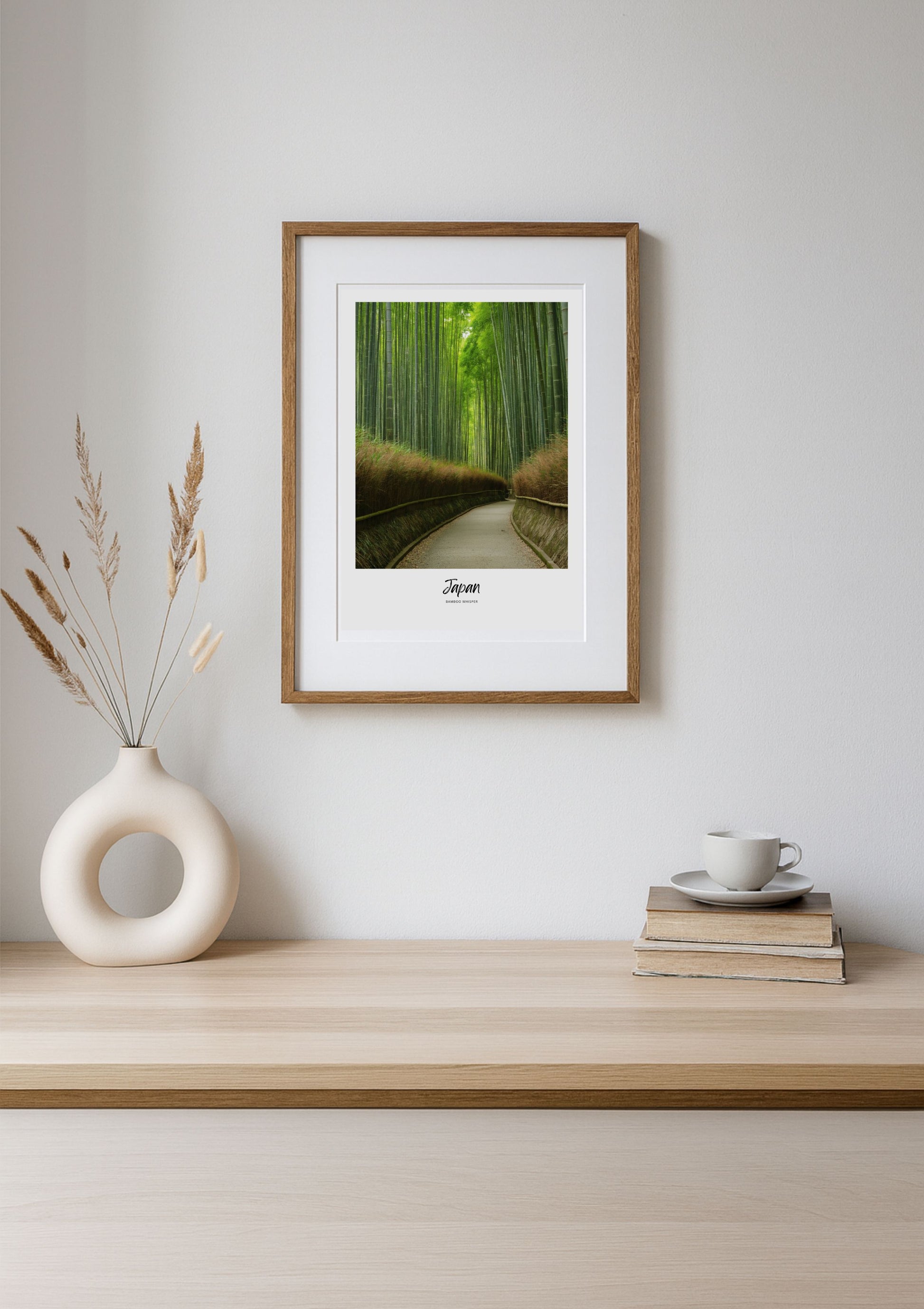 Framed print of a bamboo forest on a wall above a wooden shelf with decor items.