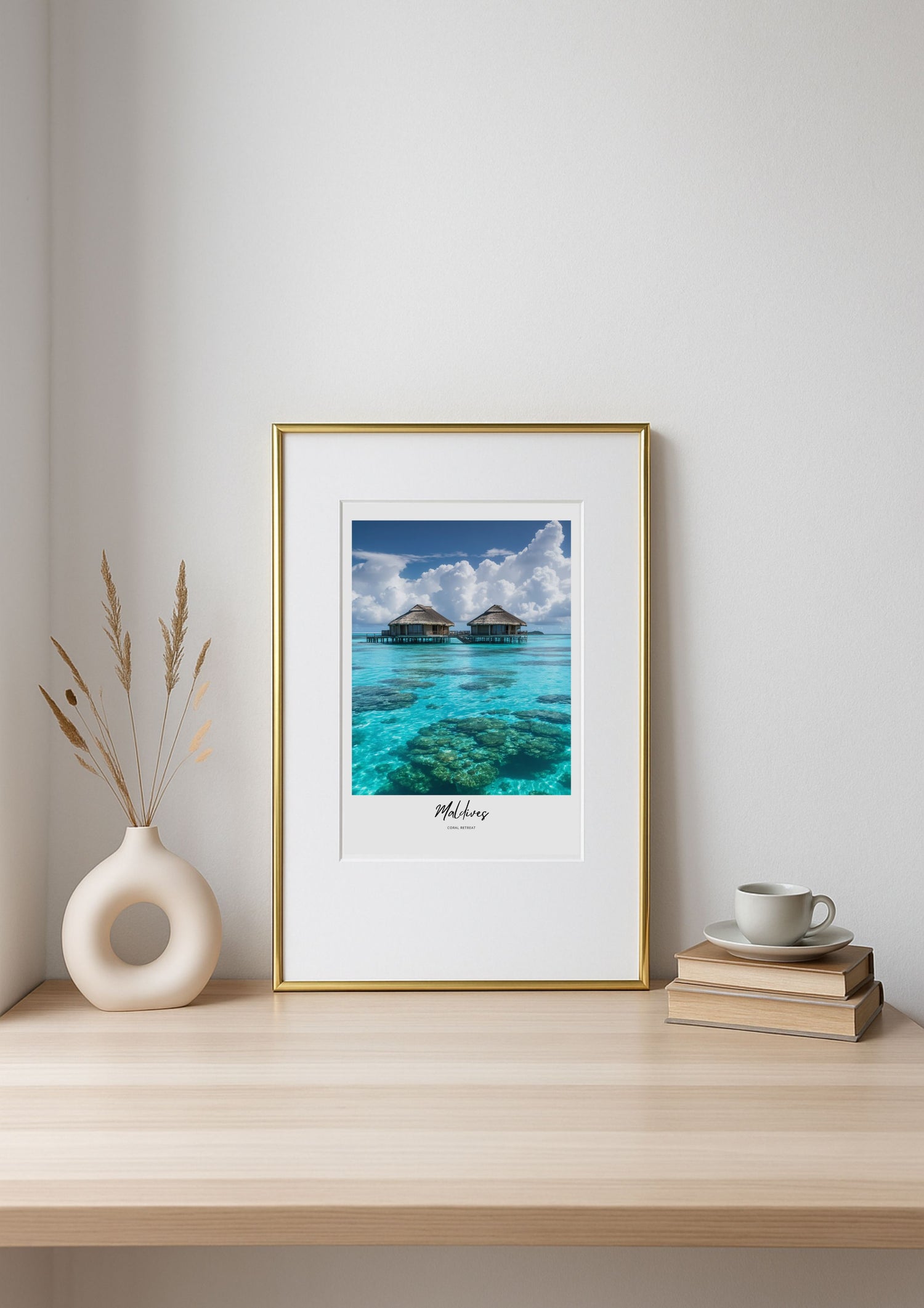 Framed photograph of a tropical beach scene on a shelf with decor items.