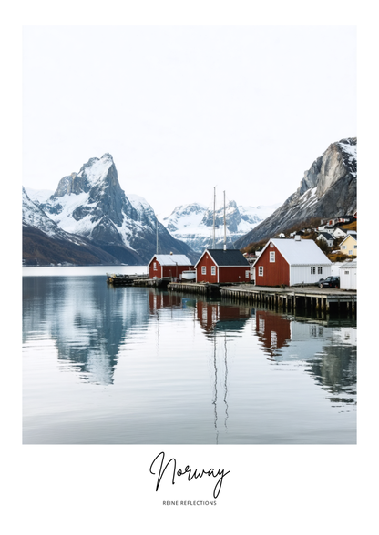 Scenic view of a fjord with red cabins and snow-capped mountains in Norway.