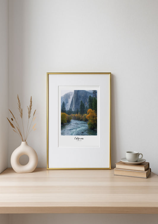 Framed landscape print of a mountain scene on a wooden shelf with decor items.